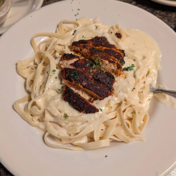 Piazzano's fettuccine alfredo with blackened chicken, topped with fresh parsley.