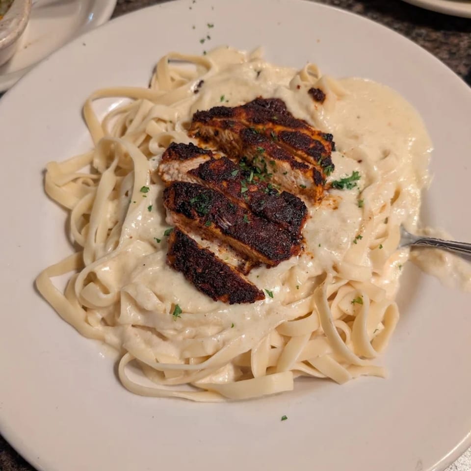 Piazzano's fettuccine alfredo with blackened chicken, topped with fresh parsley.